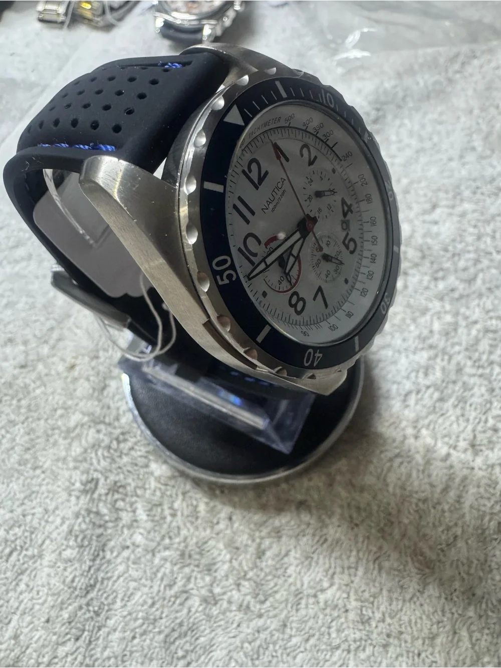 Nautica Silver Case White Dial Watch with Blue Bezel and Red Accents